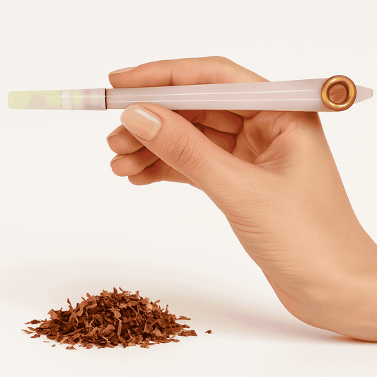 Hand holding a pink mewakh pipe with tobacco on a white background. vape dokha UAE