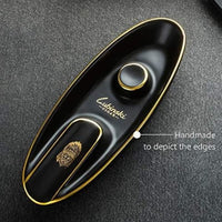 Black and gold cigar humidor with Lubinaki branding on a dark textured surface. Vape Dokha UAE