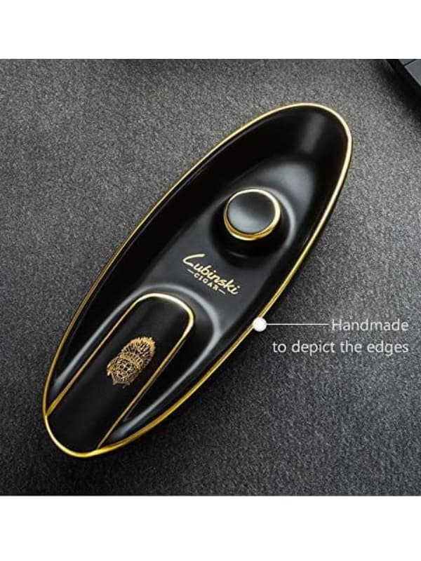 Black and gold cigar humidor with Lubinaki branding on a dark textured surface. Vape Dokha UAE