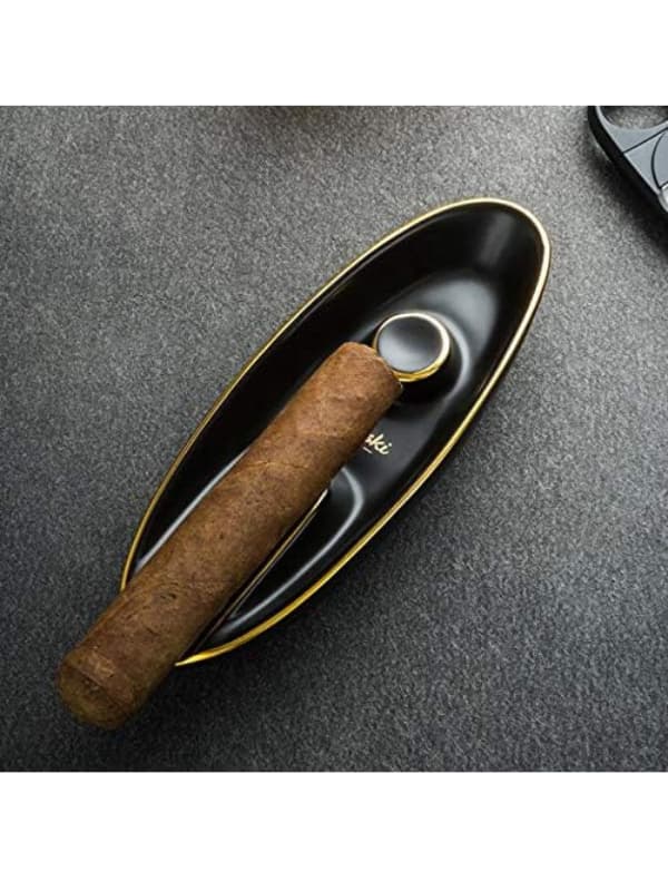 Cigar and humidor on a textured surface. Vape Dokha UAE