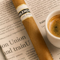 Cigar with 'Silence' label on a newspaper next to a cup of coffee. Vape Dokha UAE