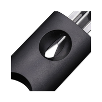 Close-up of a black cigar cutter with a metallic blade on a white background. Vape dokha UAE