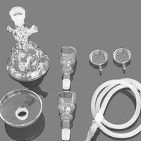 Collection of glass laboratory equipment on a gray background. Vape Dokha UAE