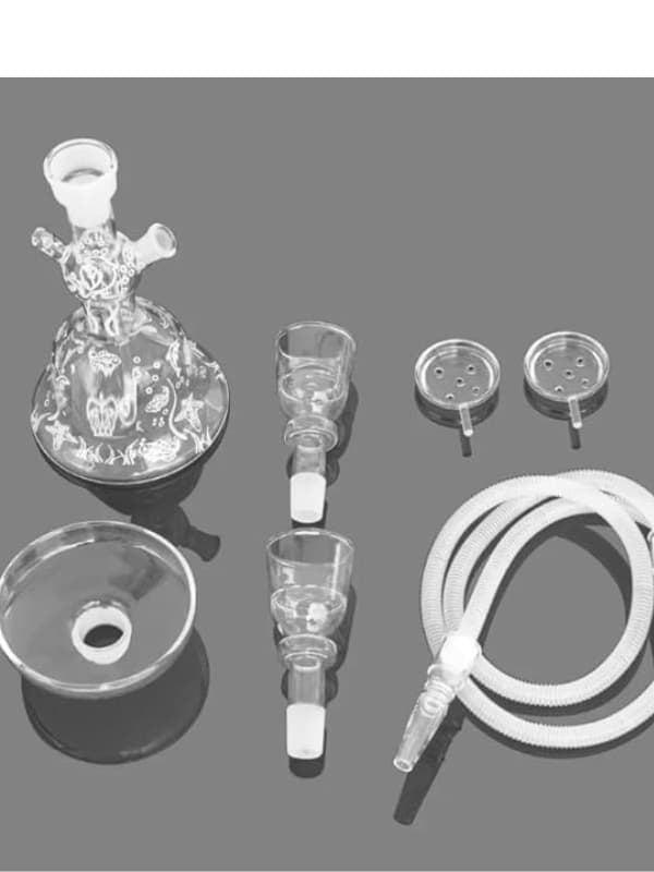 Collection of glass laboratory equipment on a gray background. Vape Dokha UAE