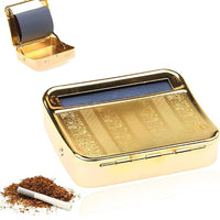 Gold cigarette case with rolling machine and tobacco on a white background.vape dokha uae