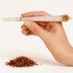 Hand holding a pink mewakh pipe with tobacco on a white background. vape dokha UAE
