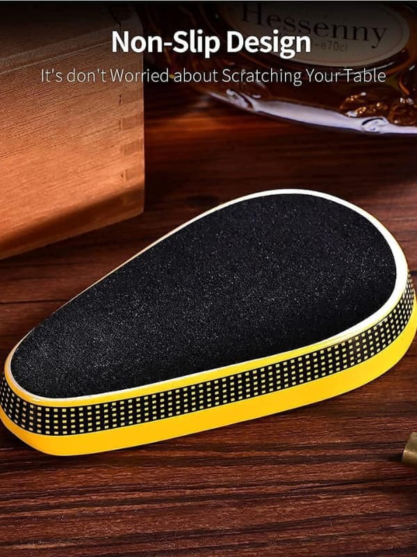 Non-slip mat with black surface and yellow border on a wooden surface.Vape Dokha UAE