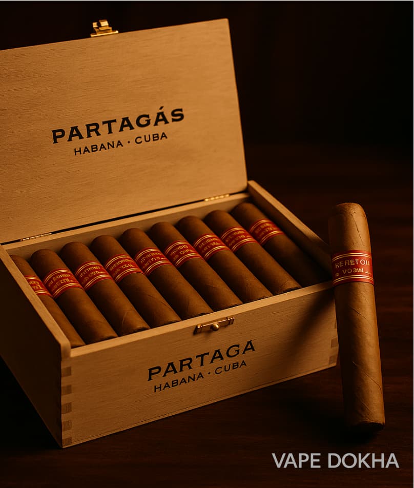 Open wooden box of Partagás cigars with a single cigar on a dark background .Vape Dokha UAE