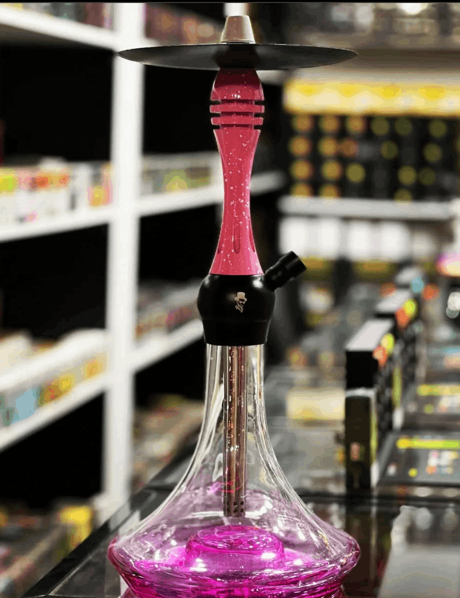 Pink and black hookah with a blurred store shelf in the background. Vape Dokha UAE