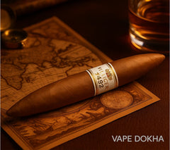 Cigar with a label on a world map, next to a glass of liquid, on a wooden surface.Vape Dokha UAE