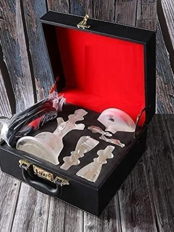 Set of white Alfakher Hookha  tools in a black suitcase with red interior on a wooden surface . Vape Dokha UAE