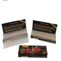 Three packages of Raw rolling paper on a white background.vape dokha uae