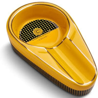 Yellow cigar ashtray with black textured surface on a white background.Vape Dokha UAE