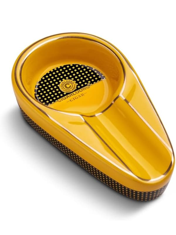 Yellow cigar ashtray with black textured surface on a white background.Vape Dokha UAE