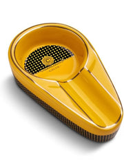 Yellow cigar ashtray with black textured surface on a white background.Vape Dokha UAE